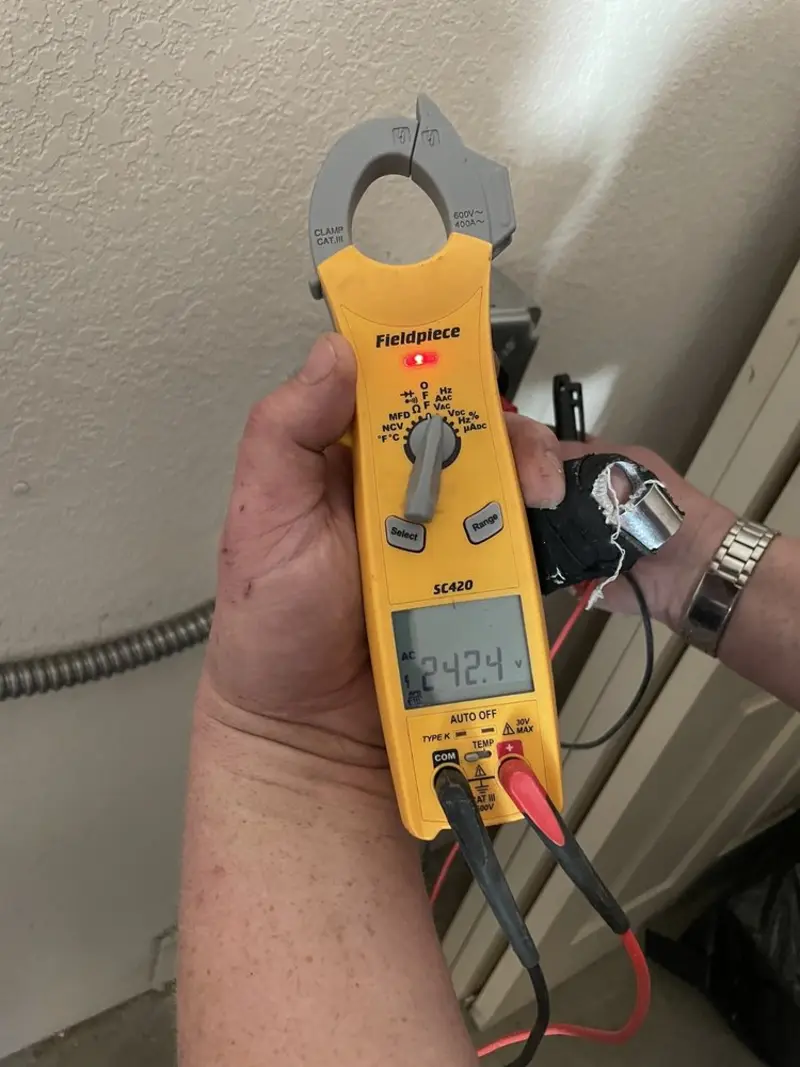 Voltage testing with clamp meter during Electrical Installation Services in Tavares